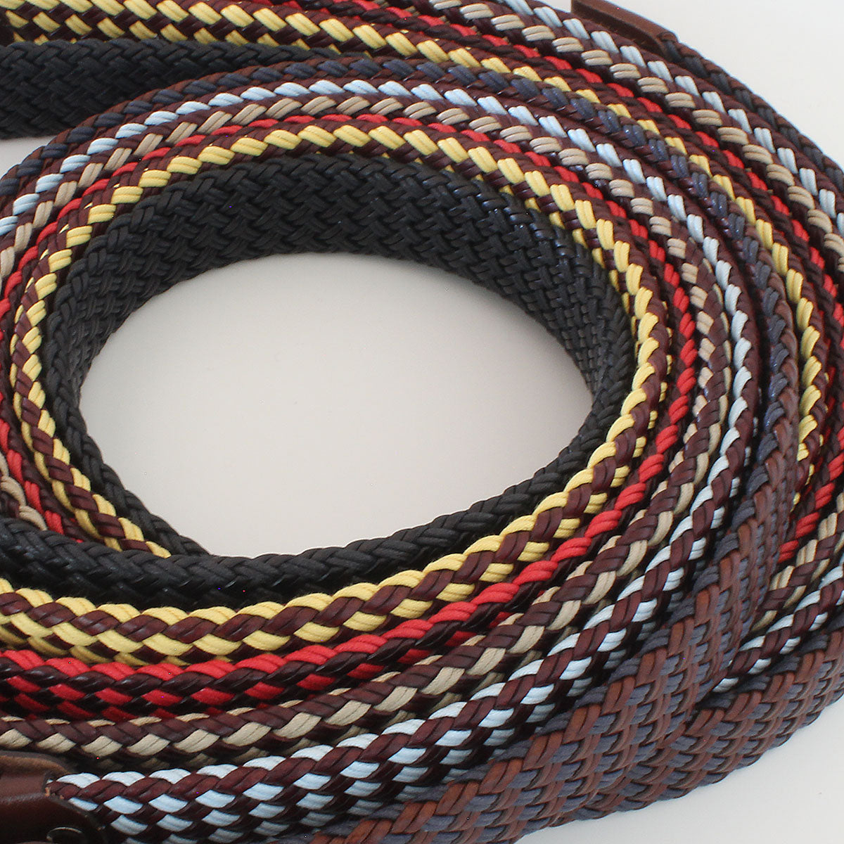 Close-up of a Robert Charles Italian braided leather belts with multicolor patterns