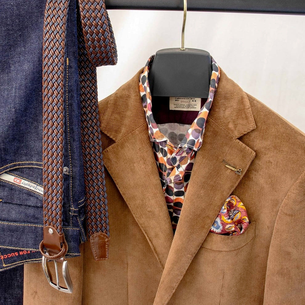 Men’s brown and blue braided leather belt with jeans and brown jacket