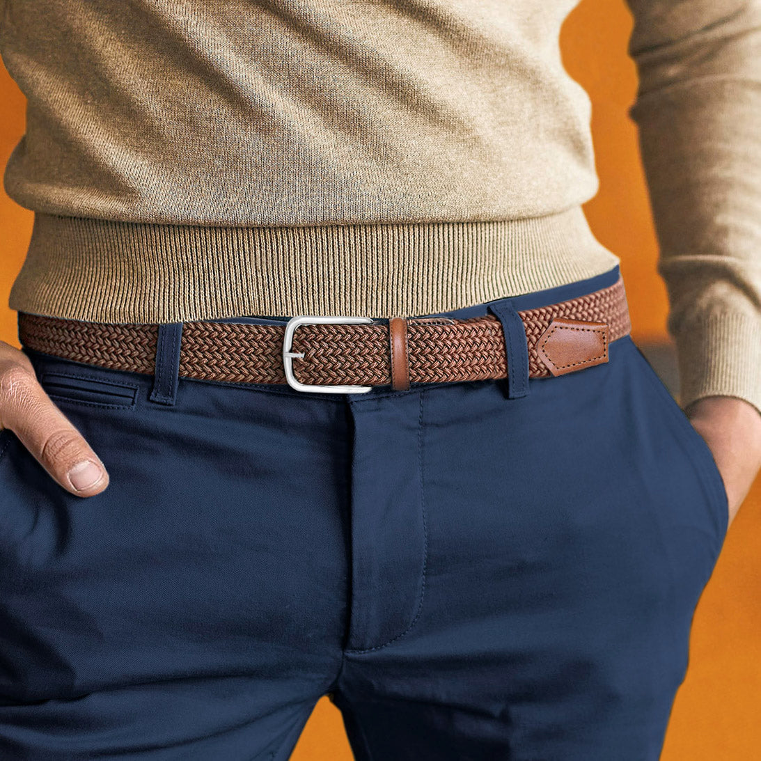 Man wearing a brown elastic belt with navy chinos and light brown sweater
