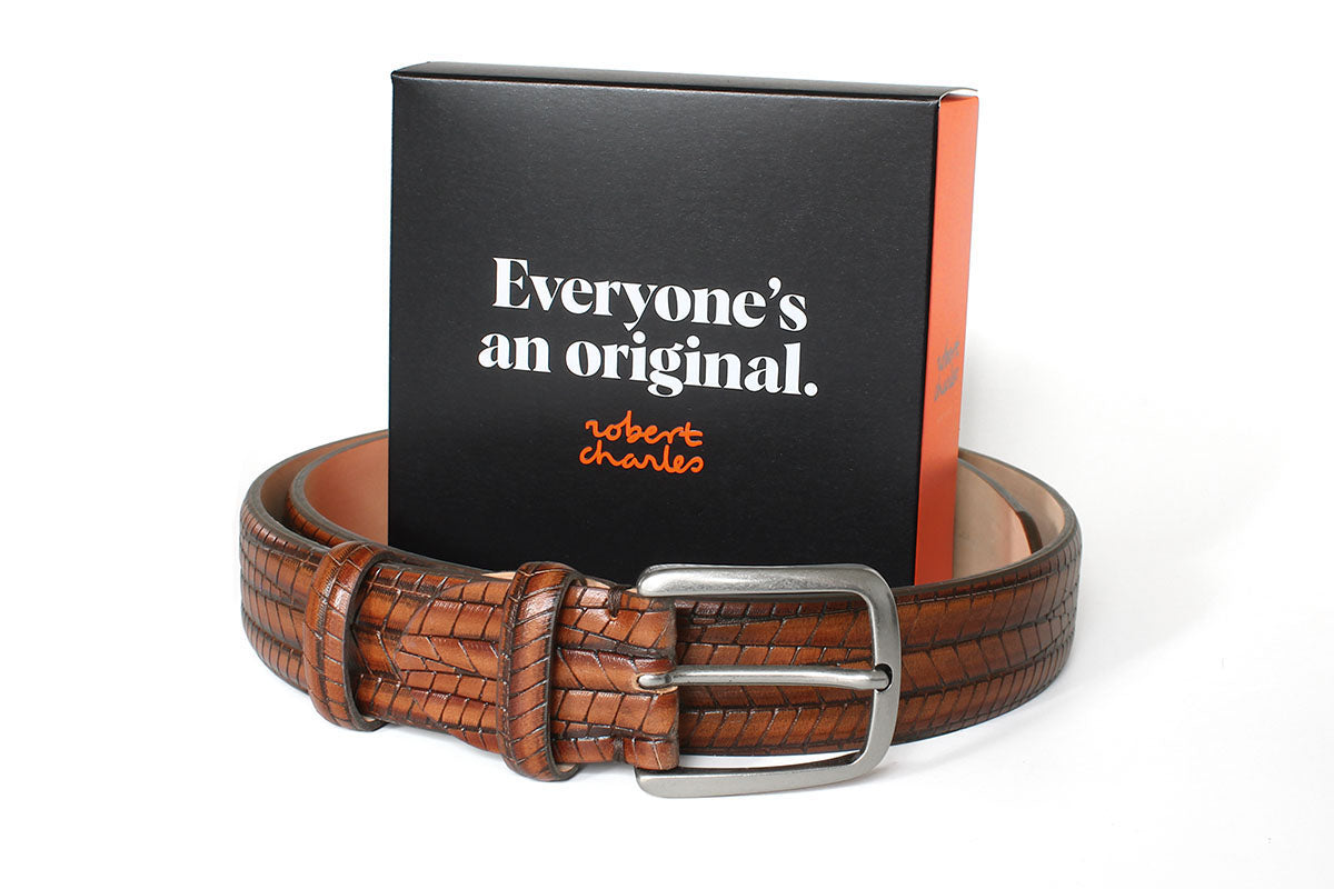 Handmade tan embossed Italian leather belt with silver buckle, displayed with Robert Charles gift box.