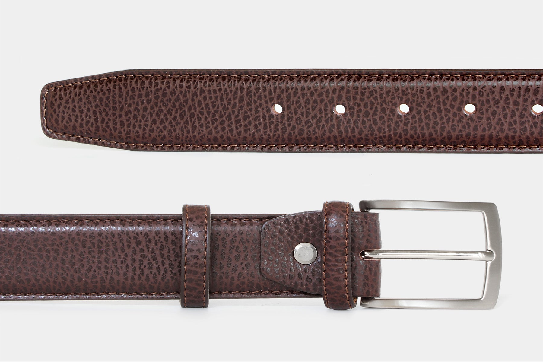 Men’s brown textured Italian leather belt, detail view of leather, stitching and solid brass buckle.
