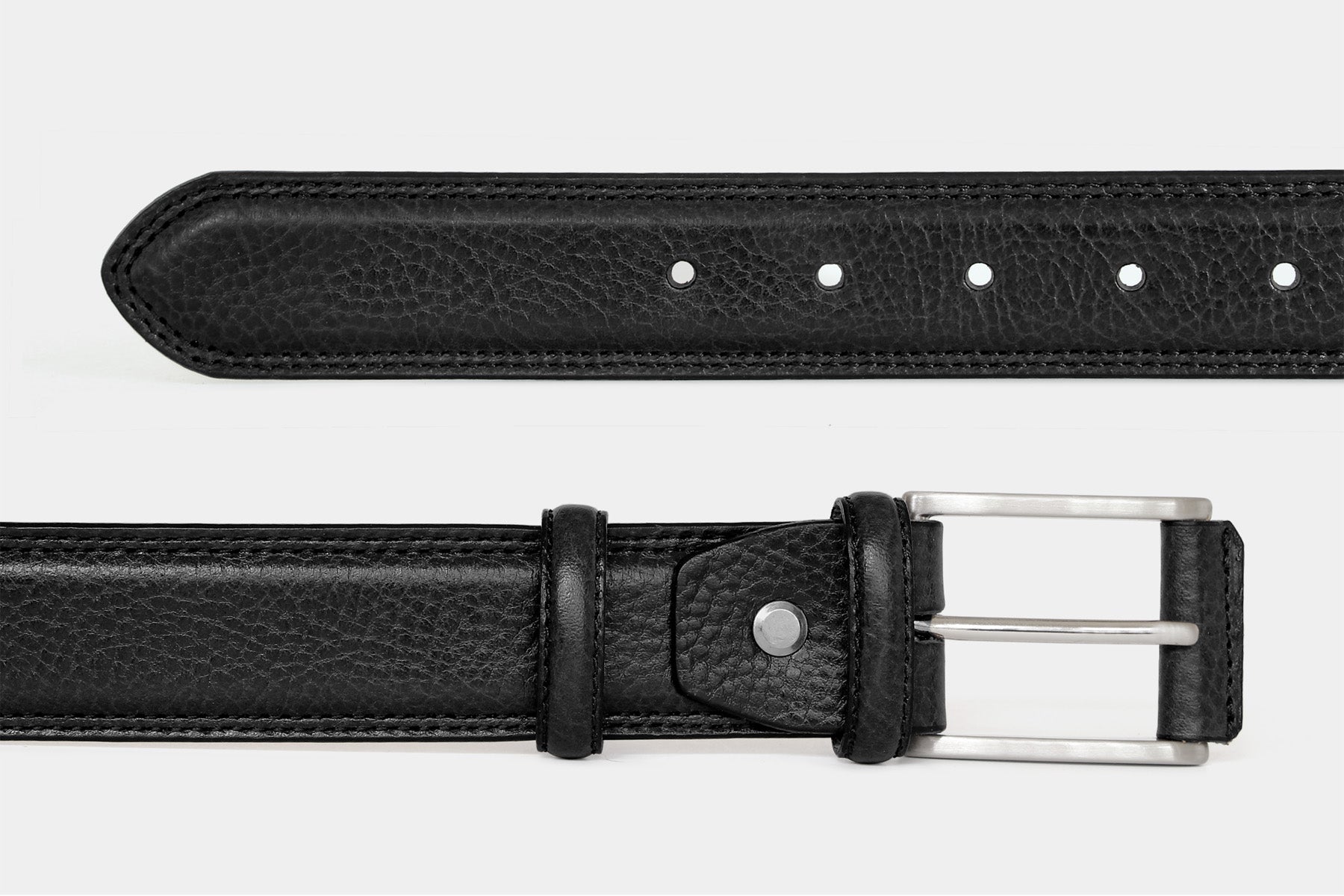 Men’s black grained Italian leather belt, detail view of double stitching and solid brass buckle with leather cover.