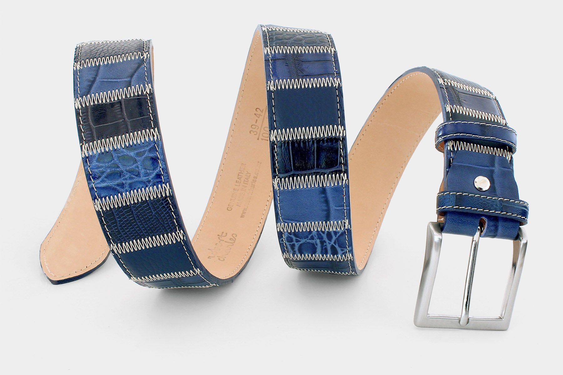 Detailed image of men’s Italian leather patchwork belt in blue tones, with solid brass buckle. Handmade in Italy.