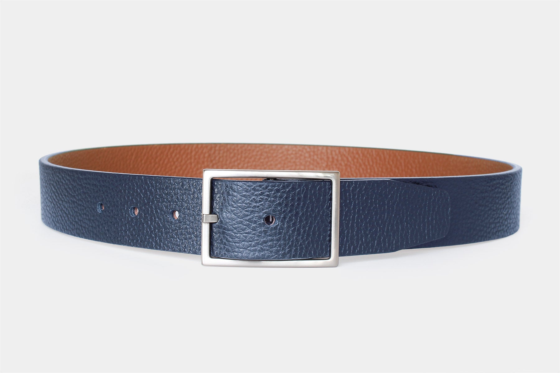 Men’s reversible navy and tan leather belt, handmade in Italy from genuine leather with a silver buckle.