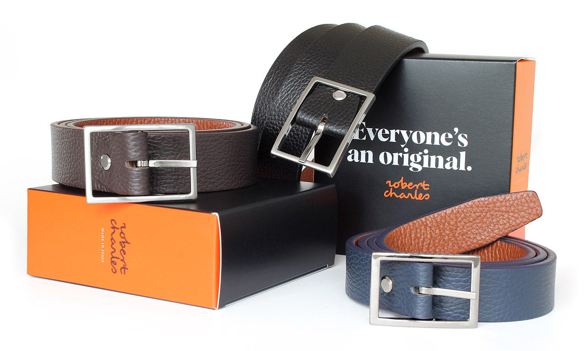 Handmade grained reversible Italian leather belts with solid brass buckle, displayed with Robert Charles gift box