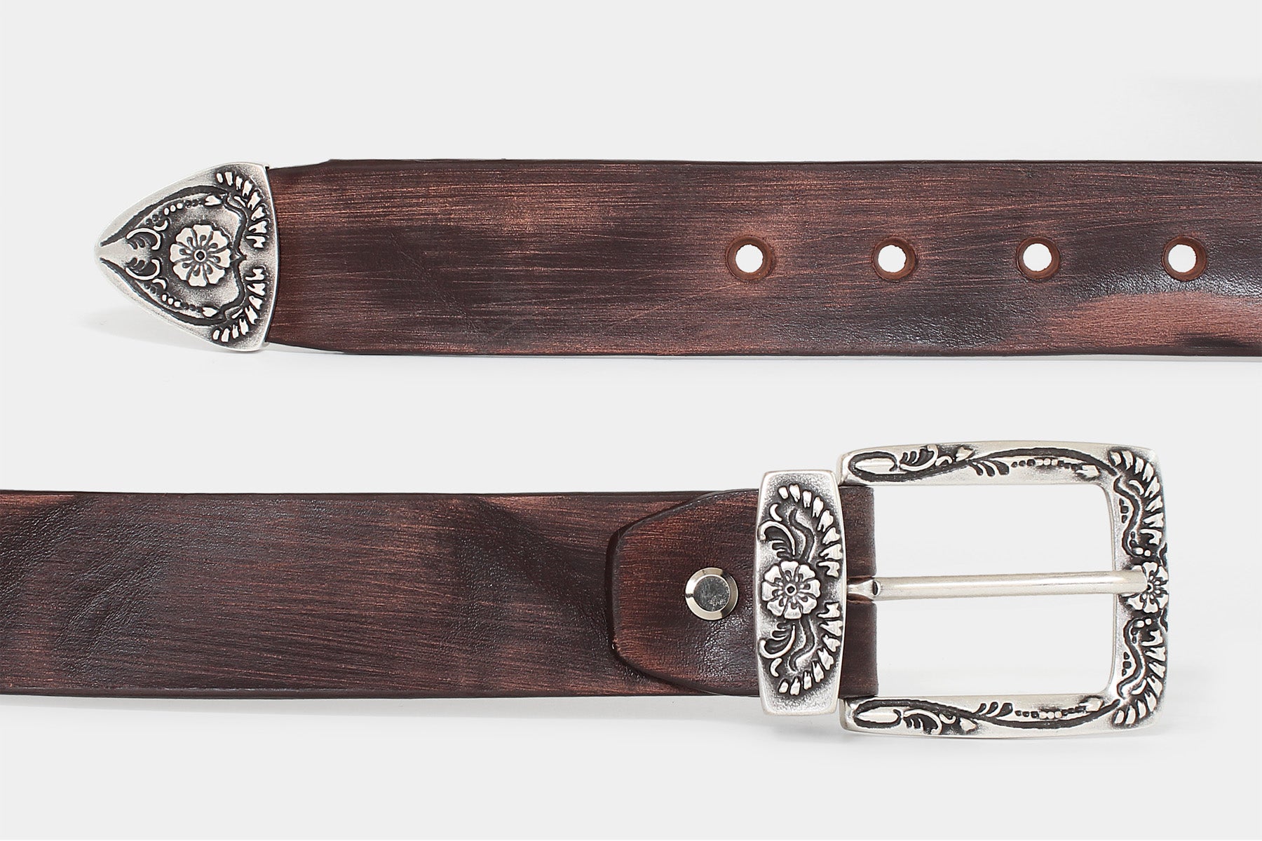 Men’s brown Italian solid hide leather jeans belt Western-style floral buckle set closeup. Distressed raw cut finish.