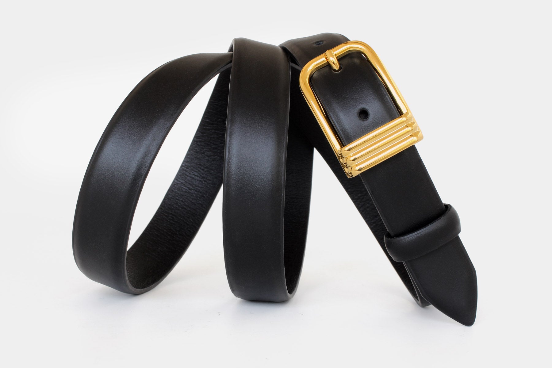 Women’s black slim Italian calfskin leather belt with gold buckle and feather edge finish. Handmade in Italy.