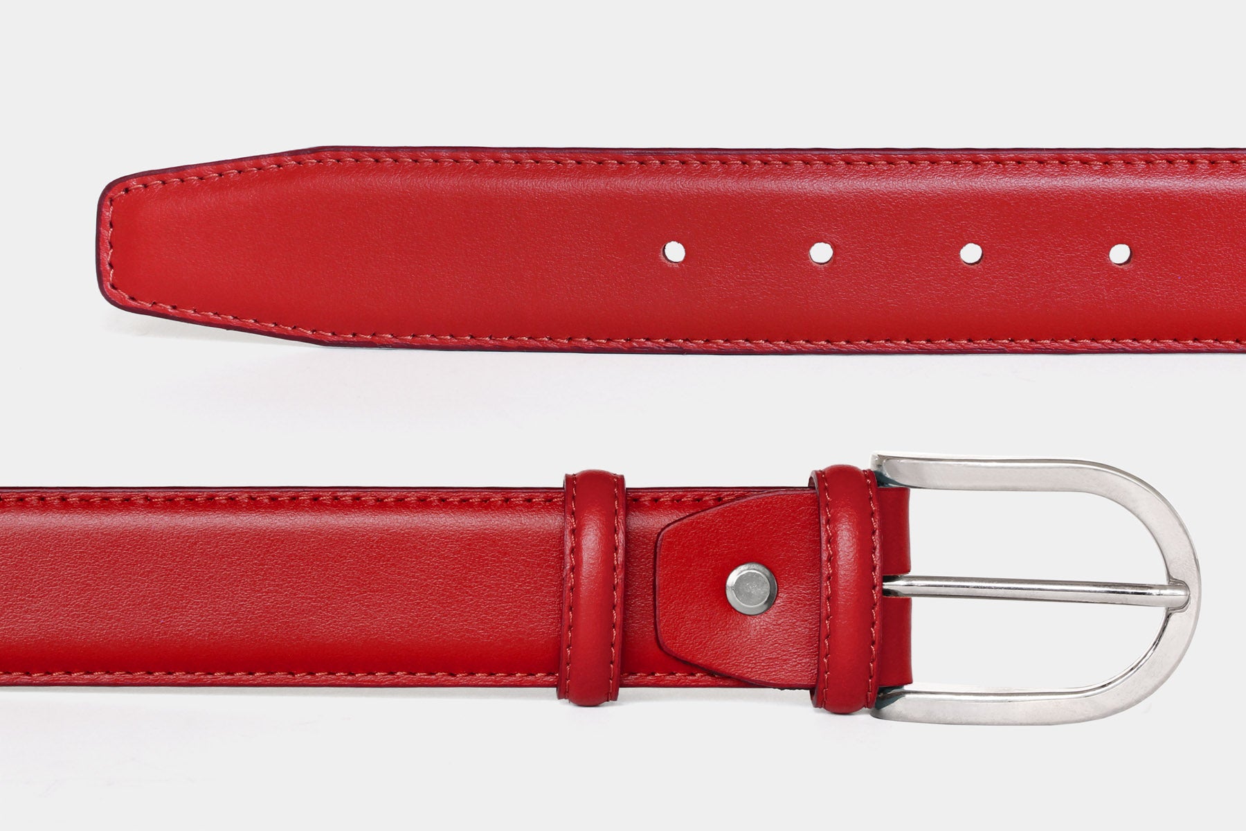 Close-up of women's red soft Italian calfskin leather belt with a polished rounded silver buckle.