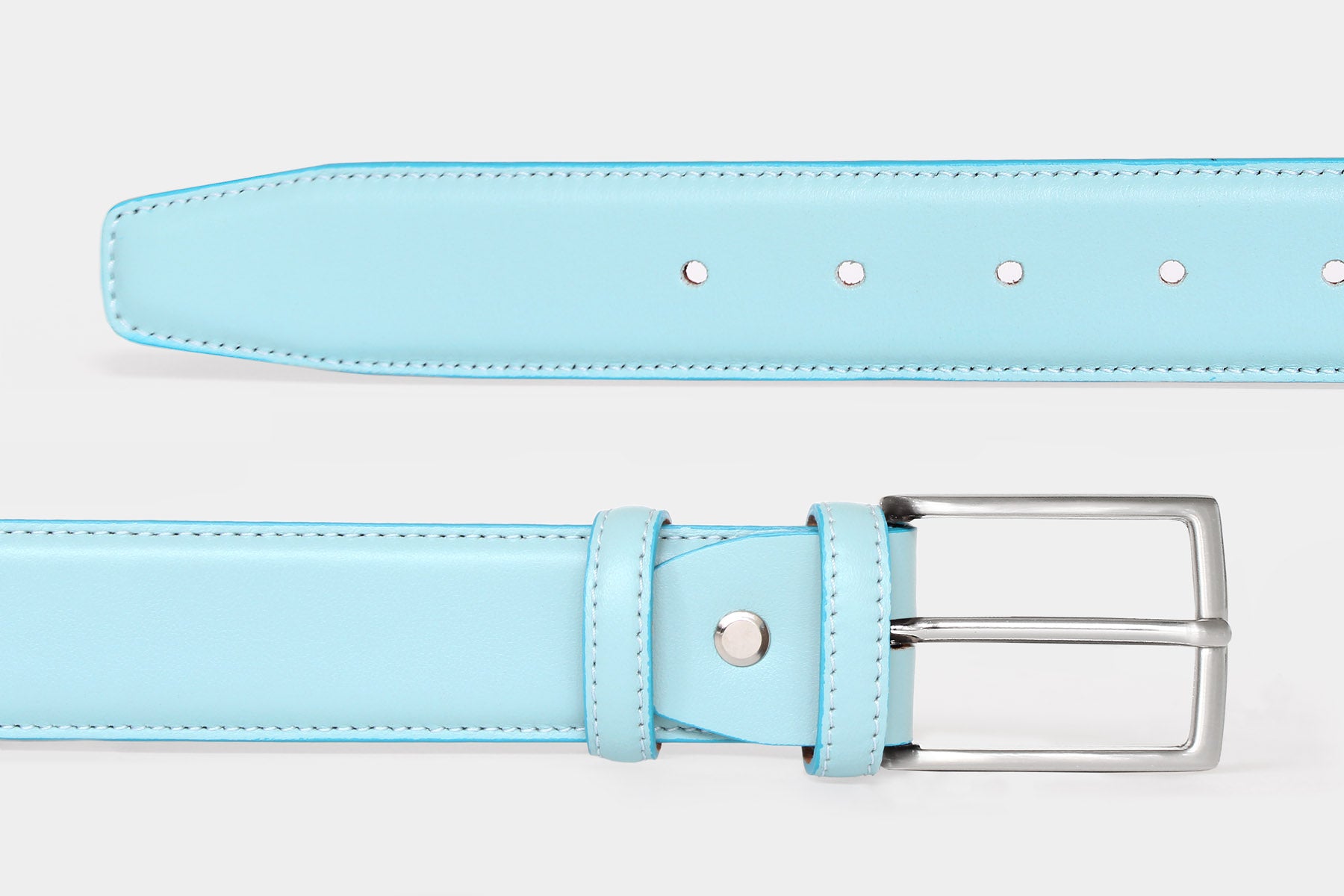 Close-up of men's ice blue soft Italian calfskin leather belt with a classic solid brass buckle. Handmade in Italy.