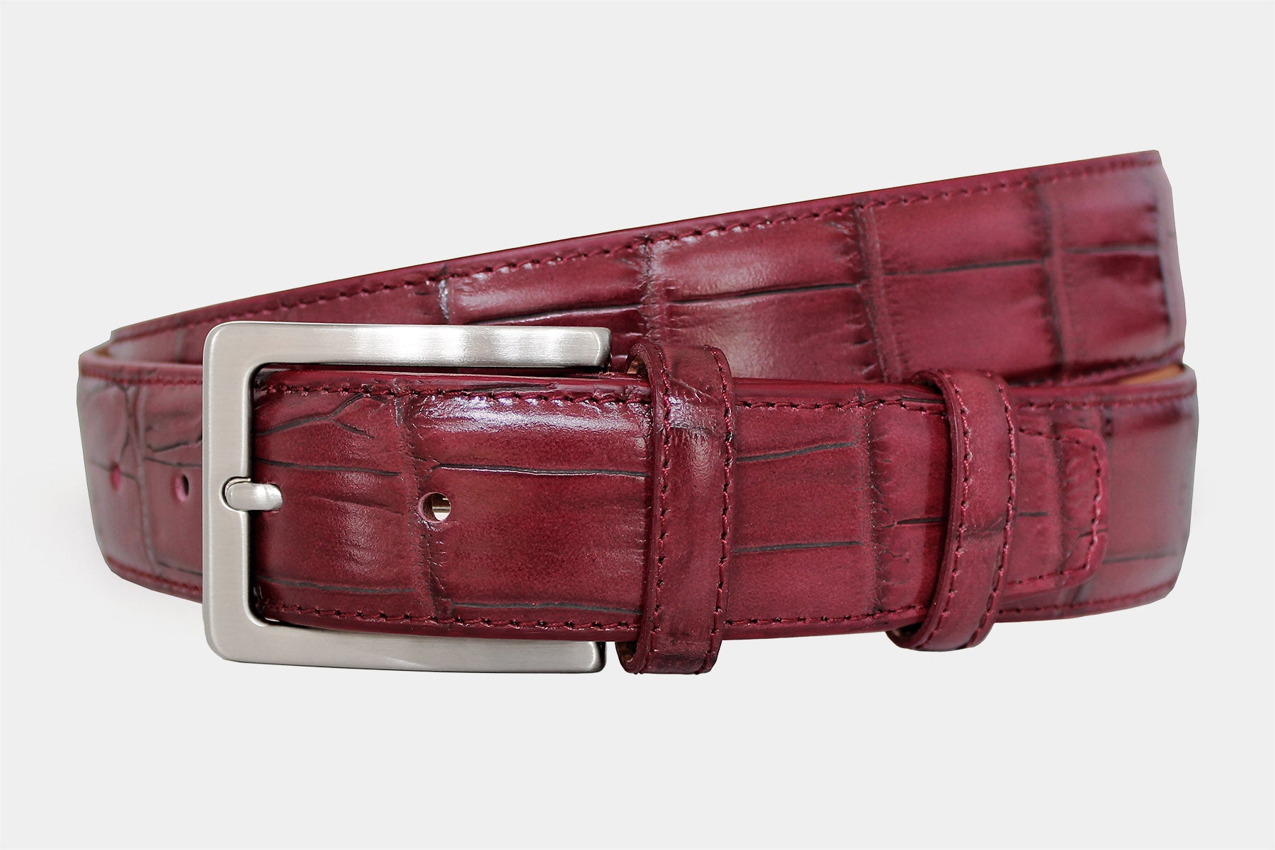 Men's bordeaux crocodile genuine leather belt handmade in Italy with silver buckle, angled product view