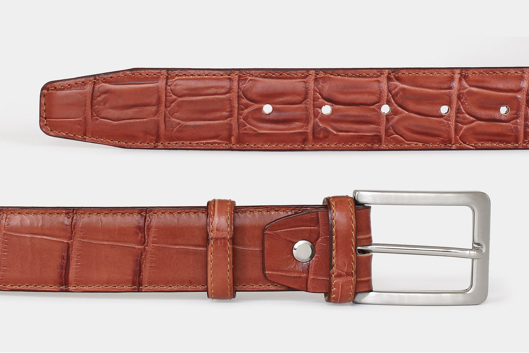 Men’s redish brown crocodile Italian leather belt, detail view of leather and solid brass buckle.
