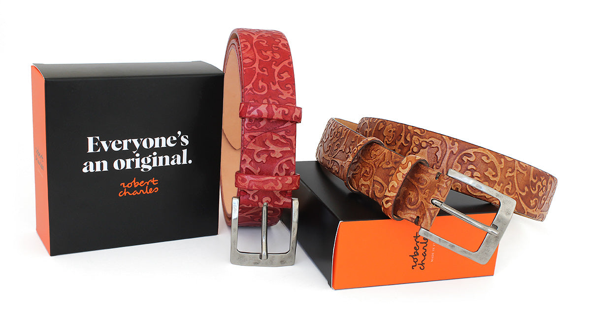 Premium embossed Italian leather belts with weathered buckle, displayed with Robert Charles gift box