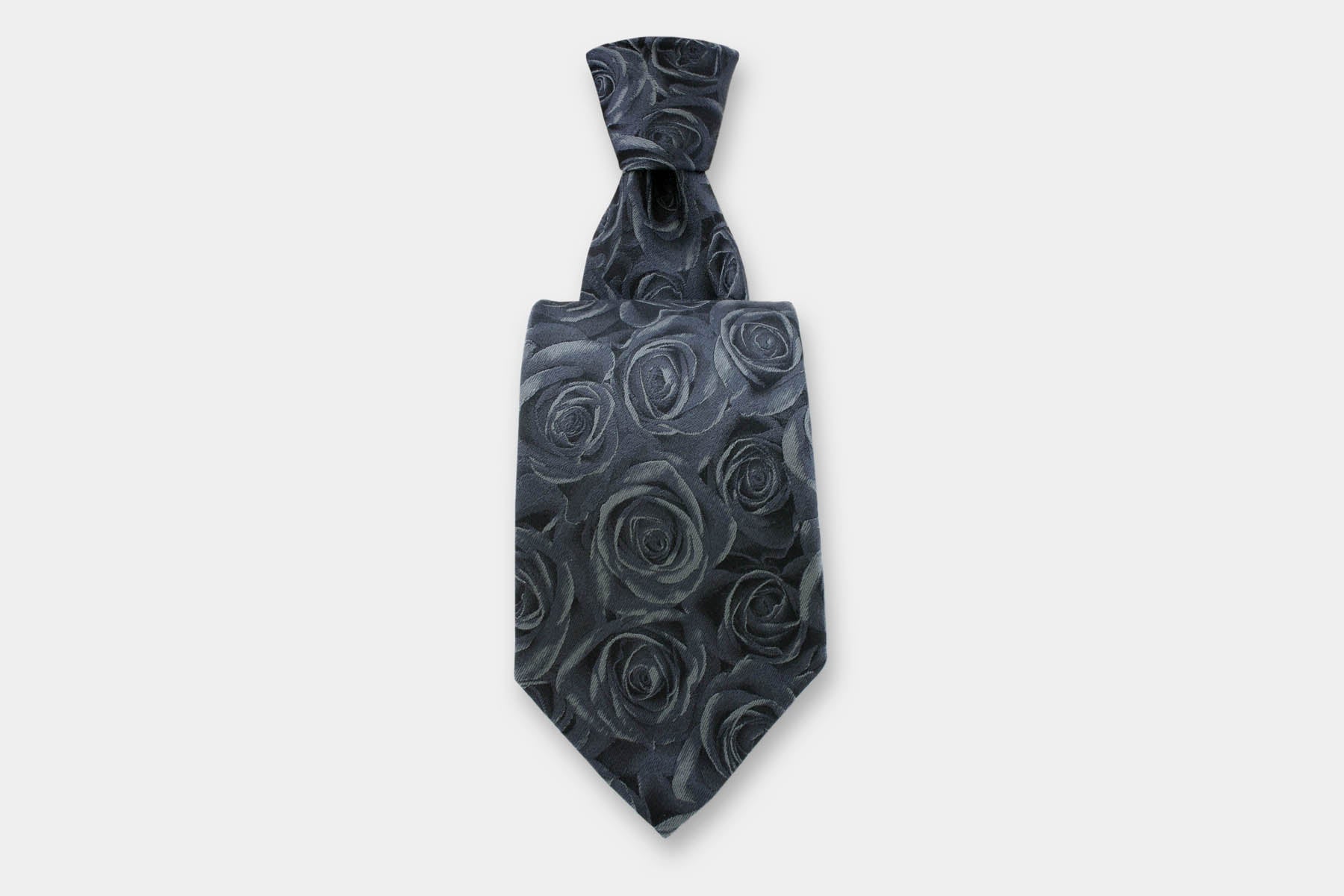 Robert Charles silk tie with a rose design in grey. Handmade in Italy, presented with a classic knot.