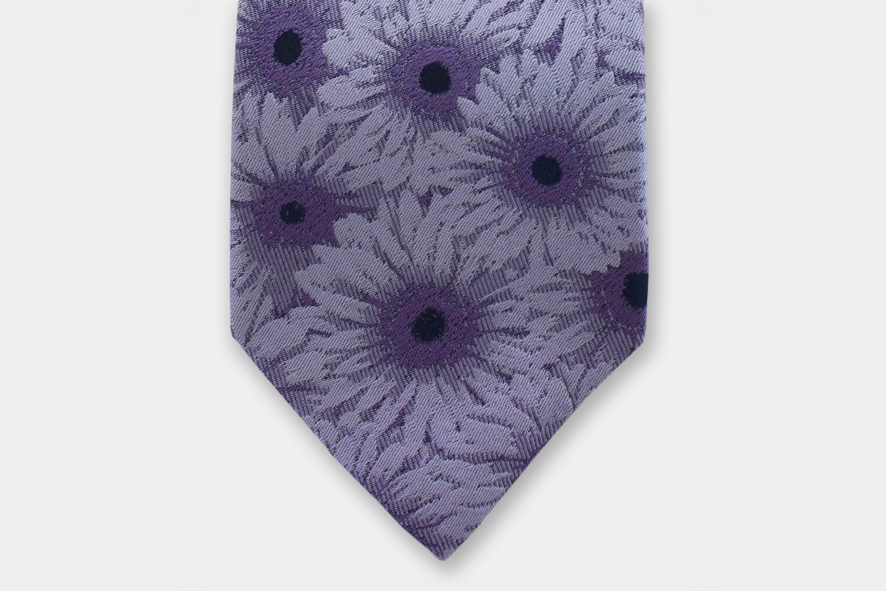 Close-up of a Robert Charles gerbera lilac silk tie showcasing the artisan Italian intricate weave.
