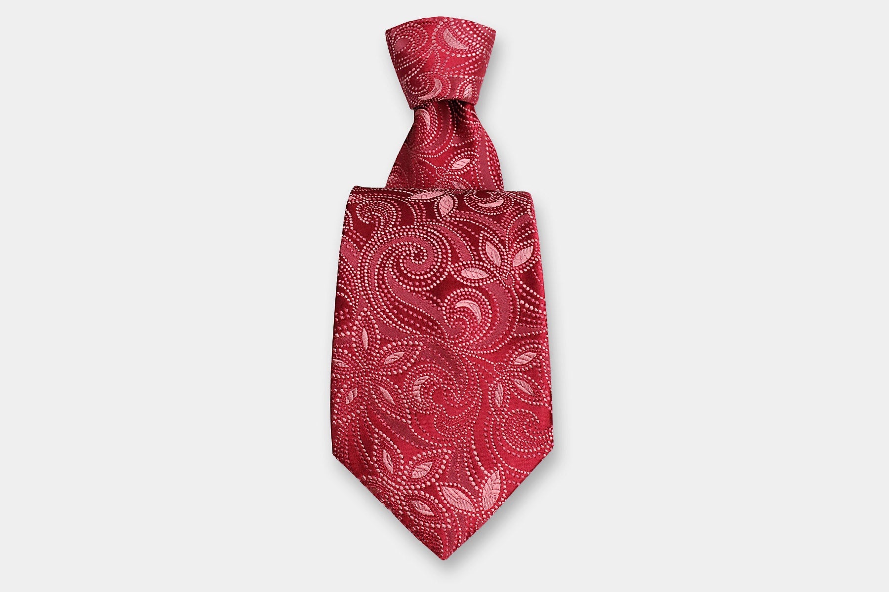 Robert Charles silk tie with a pink paisley design. Handmade in Italy, presented with a classic knot.