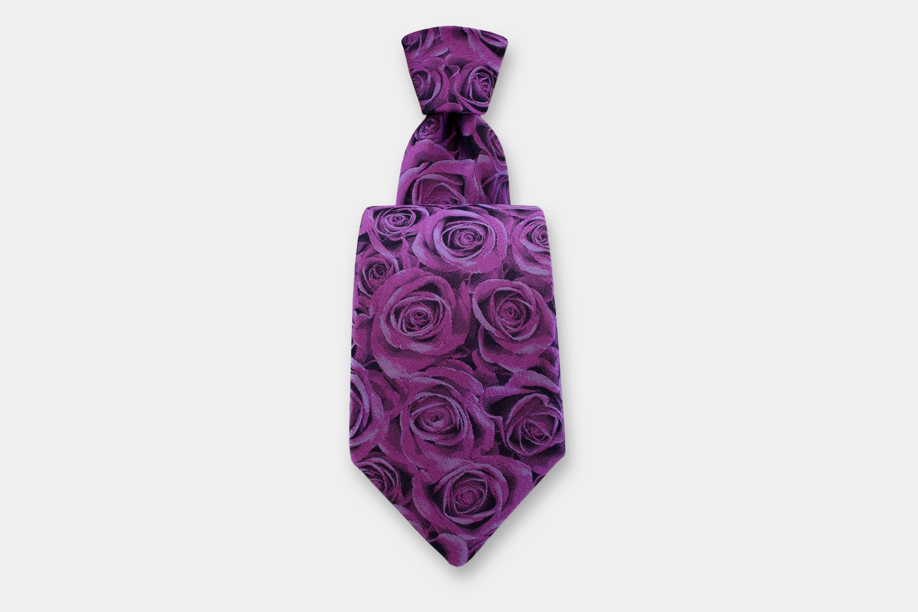 Robert Charles silk tie with a rose design in purple. Handmade in Italy, presented with a classic knot.