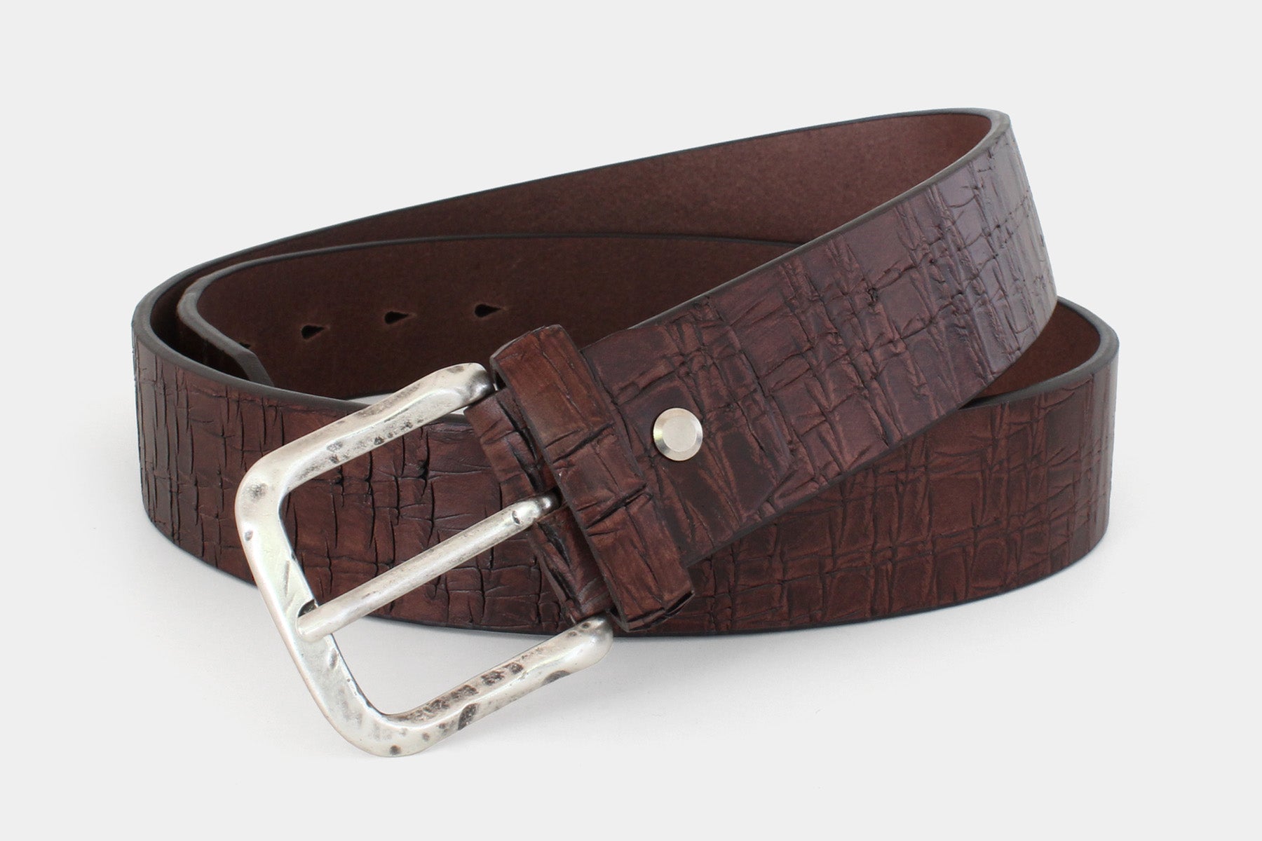 Men’s brown Italian solid hide leather jeans belt with silver buckle and authentic scored finish. 