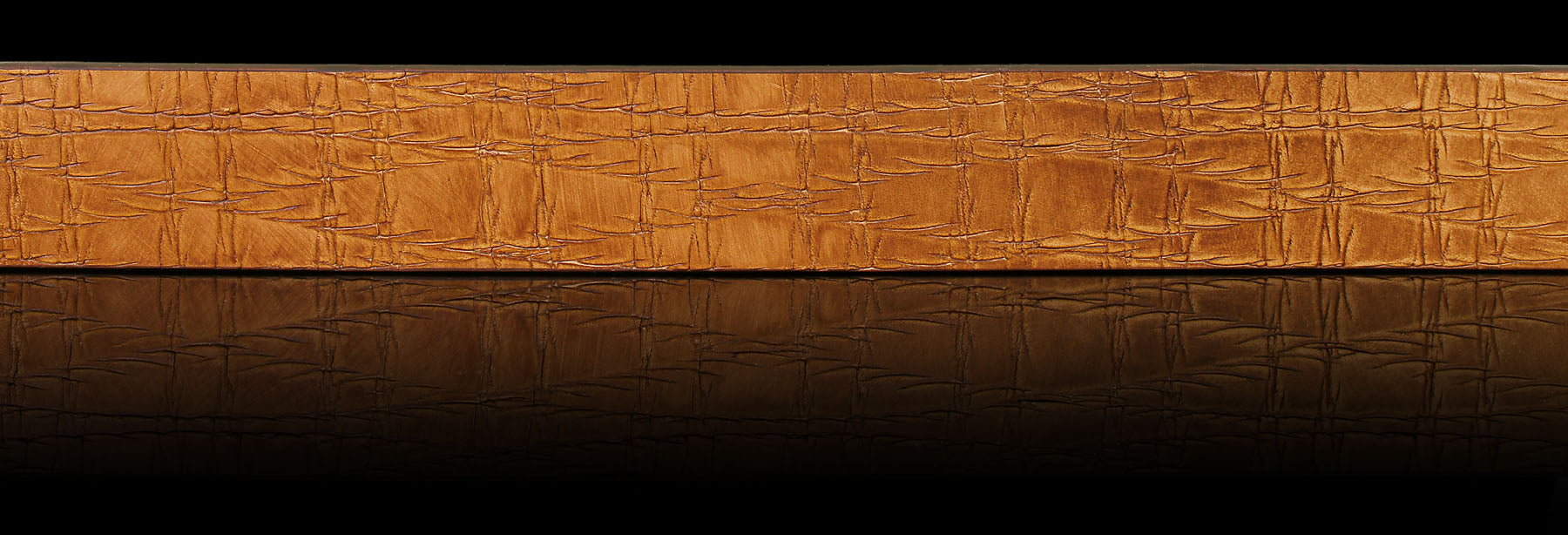 Men’s tan Italian solid hide jeans leather with authentic scored finish on black background