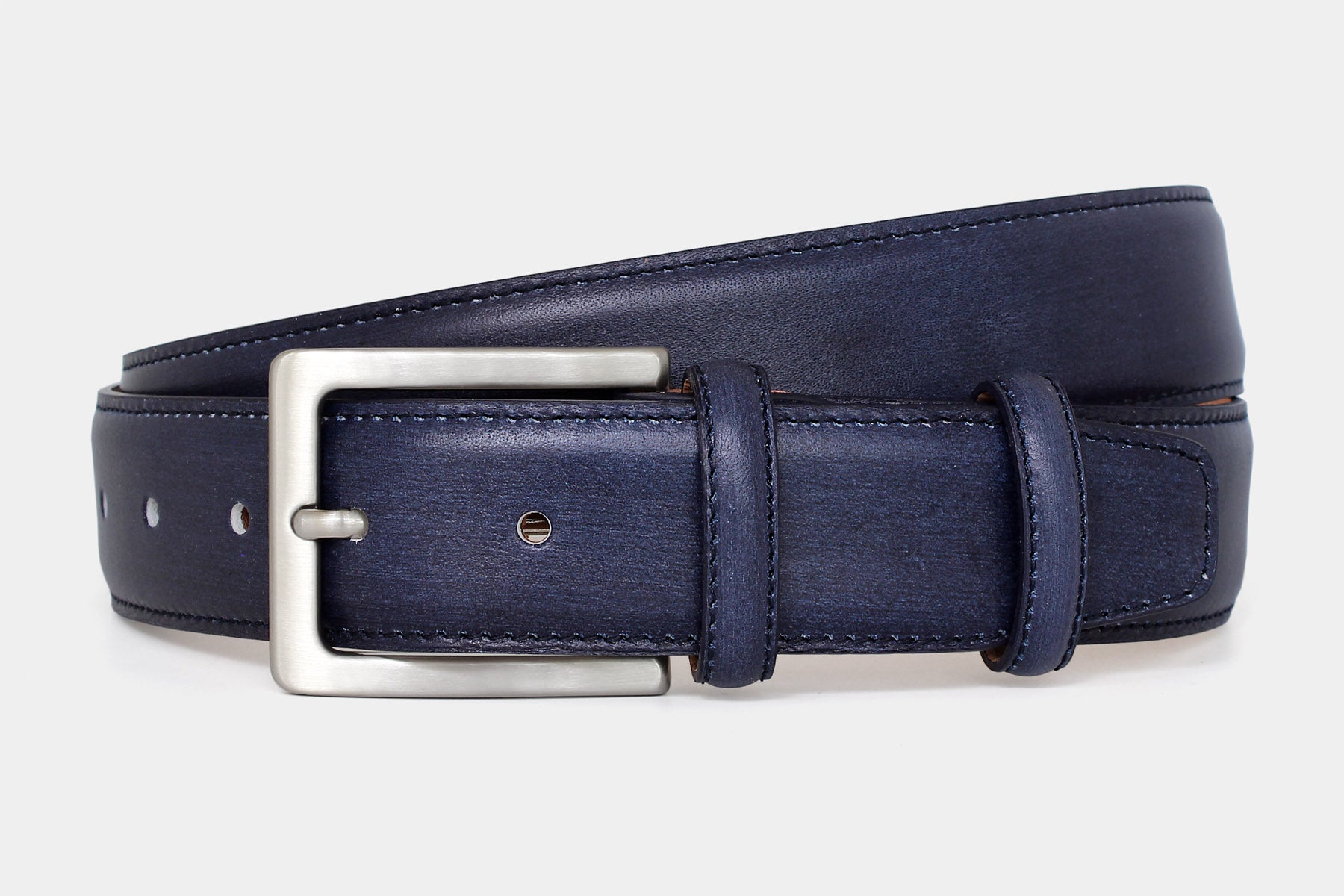 Men’s navy vegetable-tanned Italian leather belt handmade in Italy with silver buckle and stitched edge.