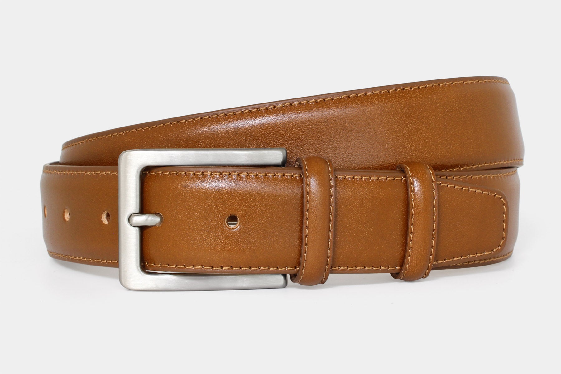 Men’s tan vegetable-tanned Italian leather belt handmade in Italy with silver buckle and stitched edge.