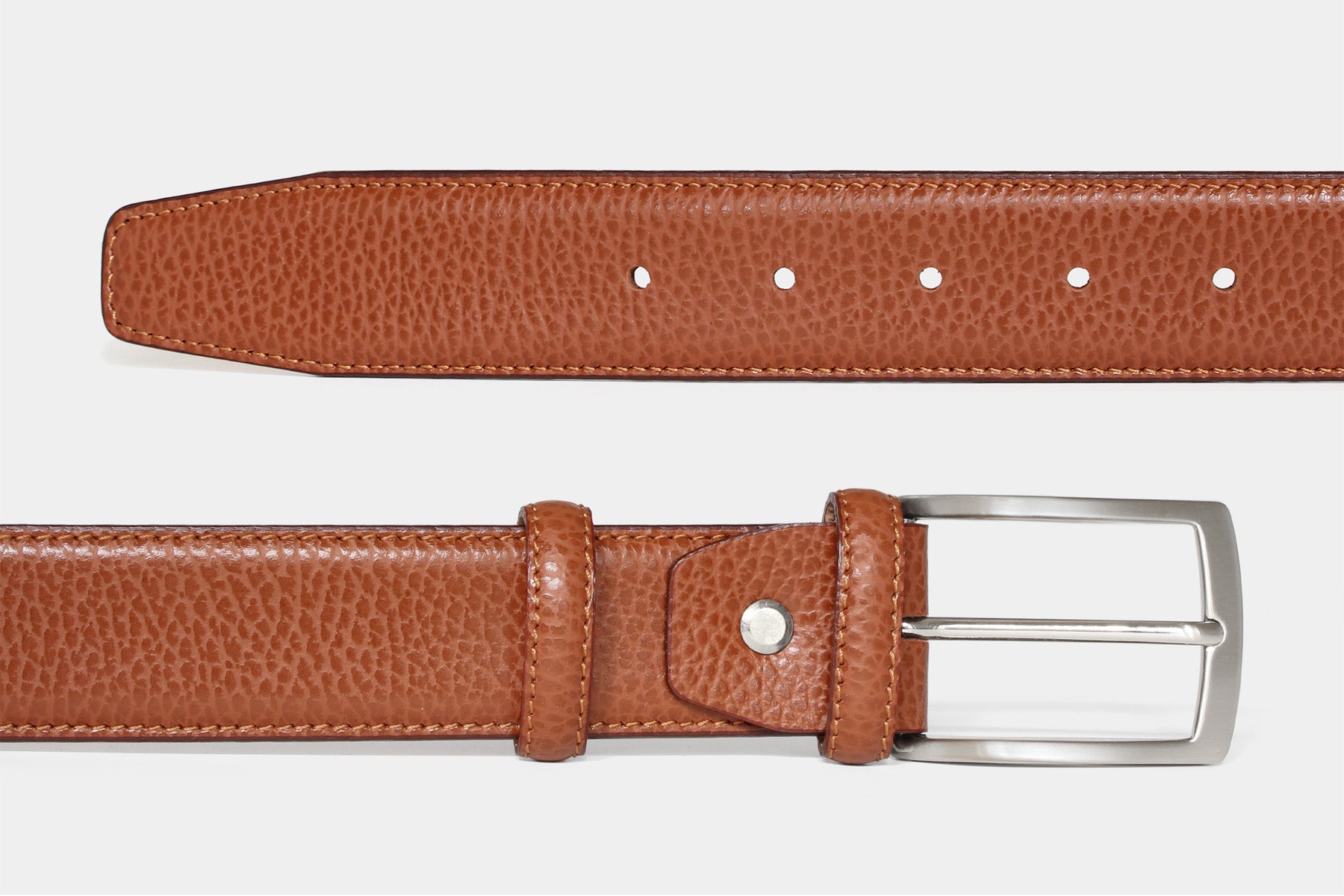 Men’s tan textured Italian leather belt, detail view of leather, stitching and solid brass buckle.