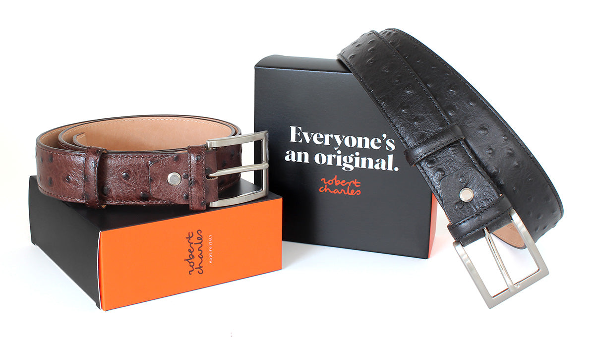 Handmade ostrich Italian leather belts with solid brass buckle, displayed with Robert Charles gift box 