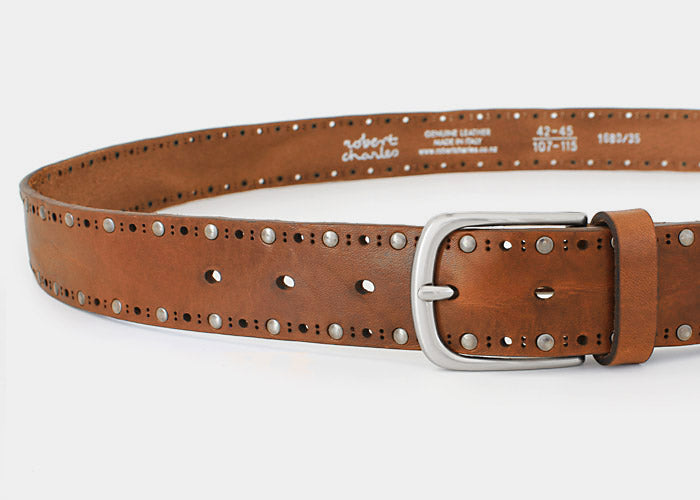 Close-up of women's tan jeans belt with studded detail and silver buckle. 35mm width. Handmade in Italy.
