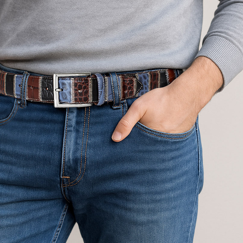 Men wearing a patchwork Italian leather belt with blue, brown and black patches with blue jeans and grey top