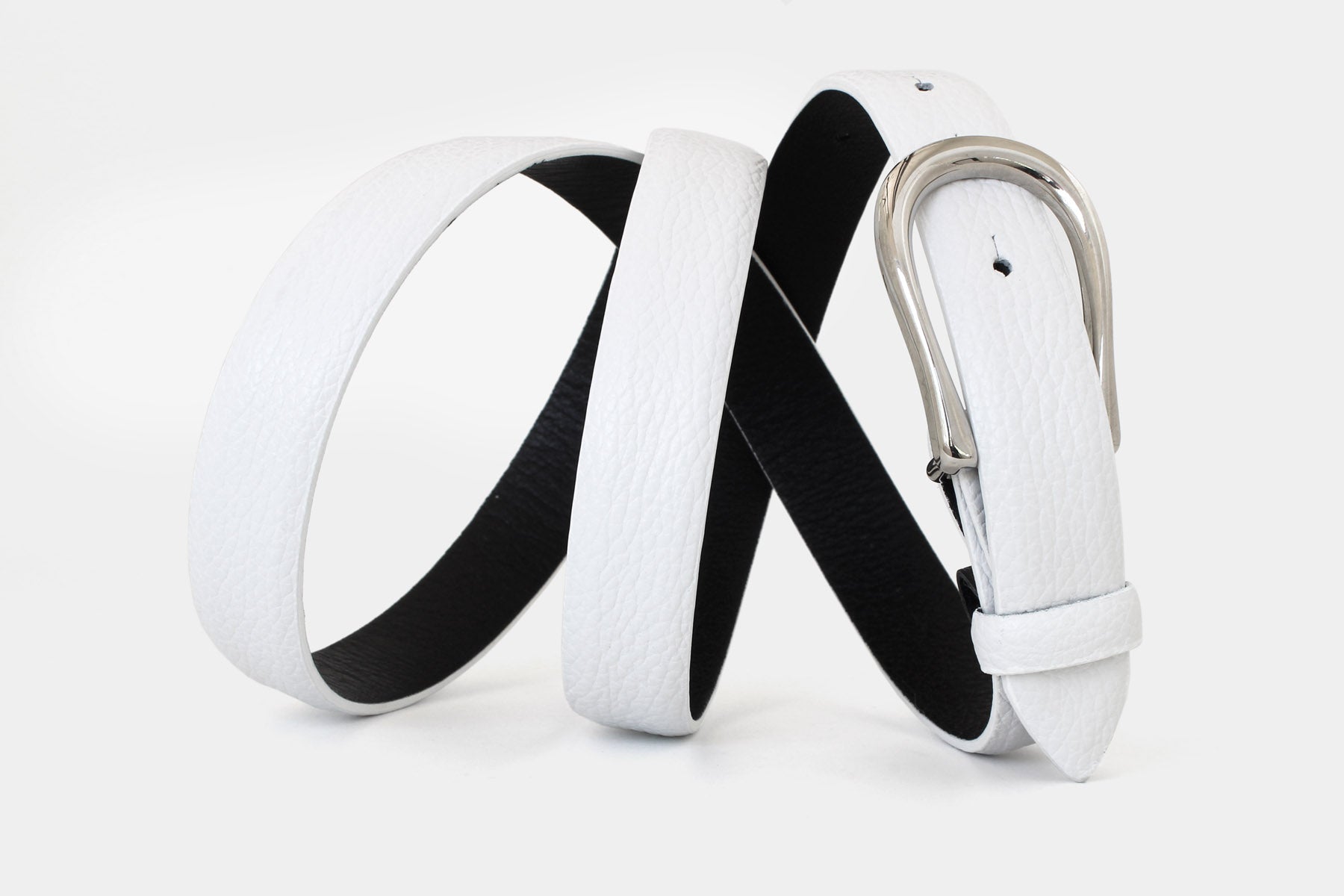 Women’s white slim Italian grained leather belt with silver buckle and black lining - feather edge finish.