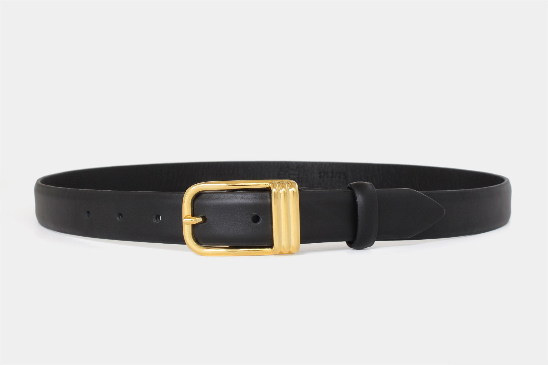 Women’s black slim Italian calfskin leather belt with gold buckle in feather edge finish. Handmade in Italy. 
