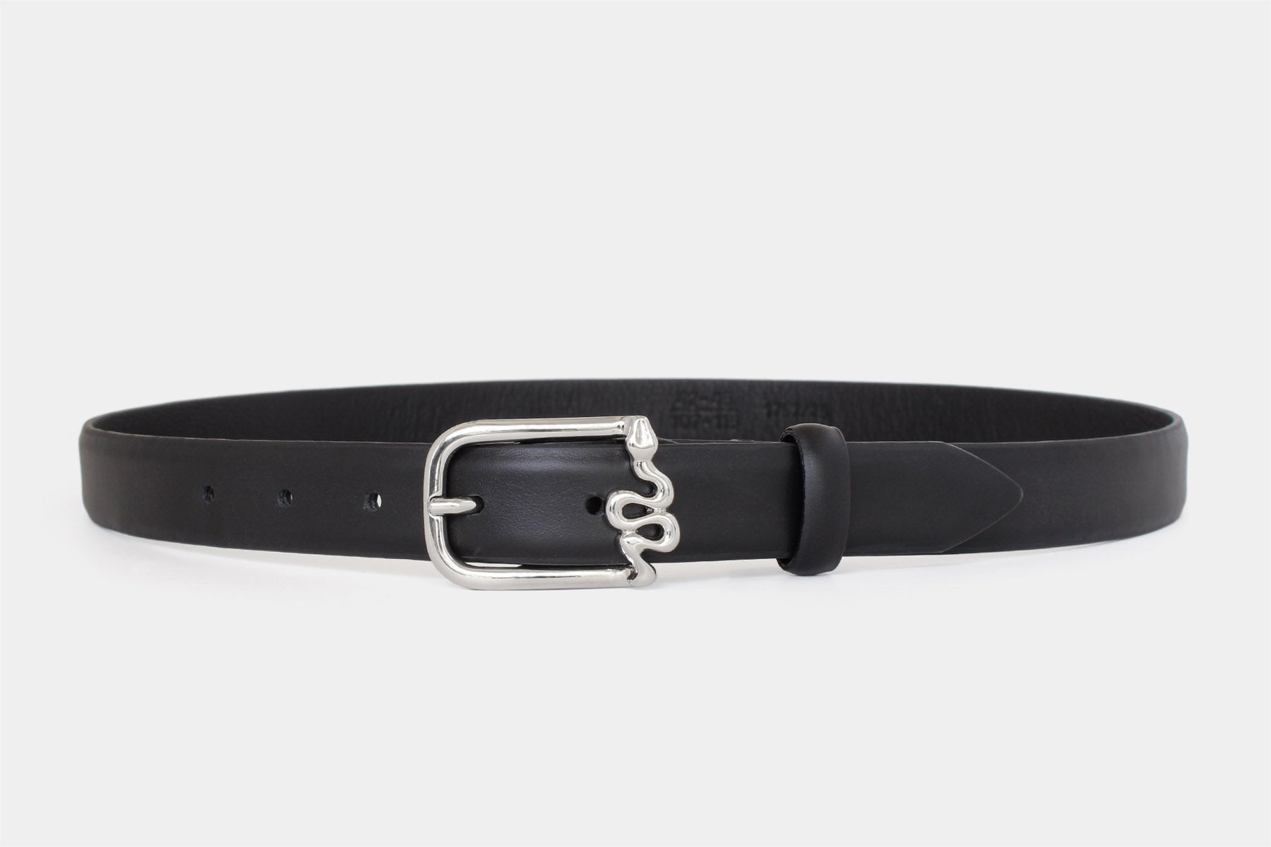 Women’s black slim Italian calfskin leather belt with silver serpentine buckle in feather edge finish. 