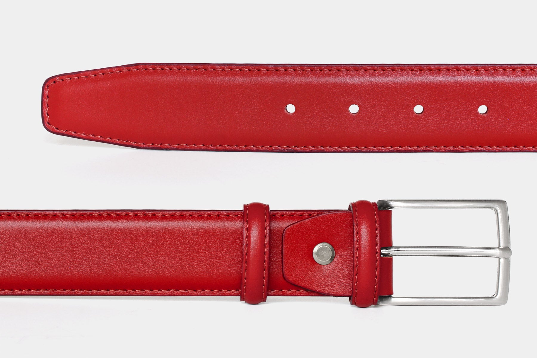 Close-up of men's red soft Italian calfskin leather belt with classic silver buckle. Made in Italy.
