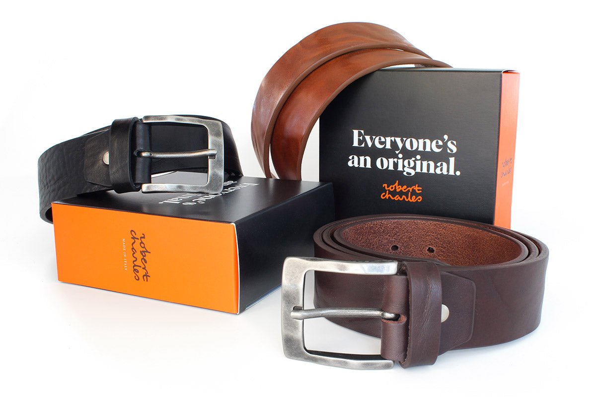 Handmade solid hide Italian leather jeans belts with weathered buckle, displayed with Robert Charles gift box 