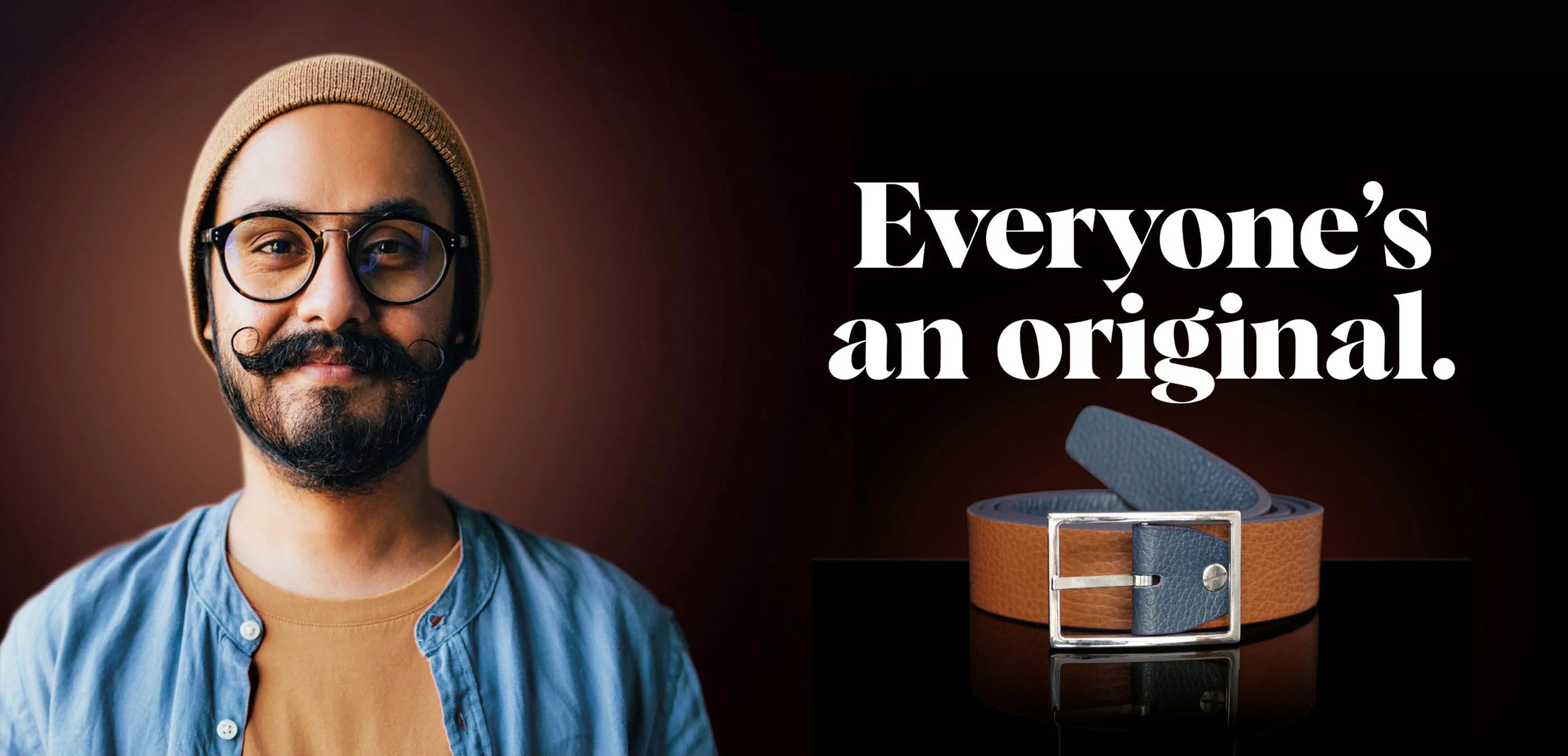 Two-tone brown and navy Italian leather Robert Charles belt beside casually styled man. Made in Italy.