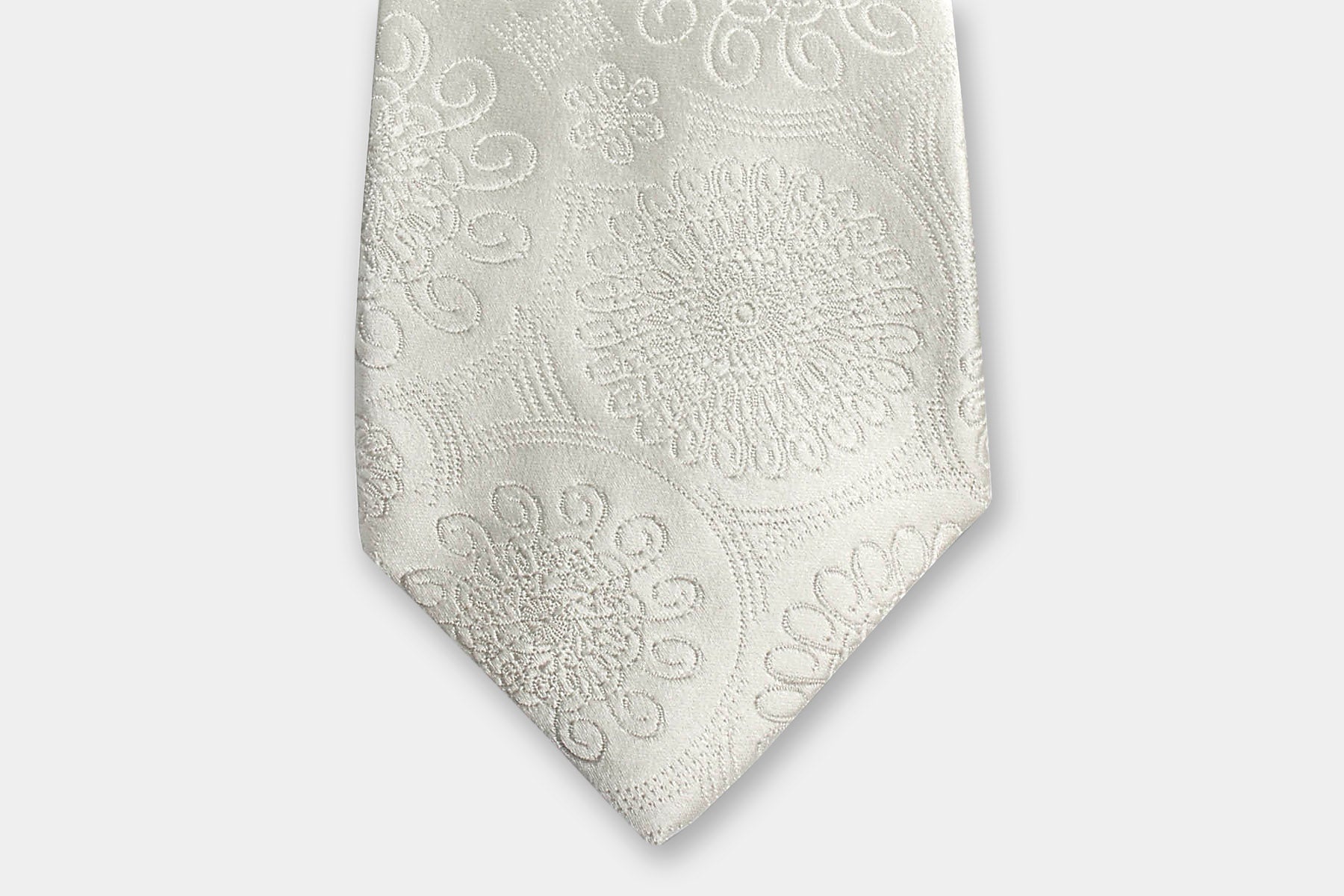Close-up of a Robert Charles ivory silk tie with an intricate floral weave perfectly suited for weddings.