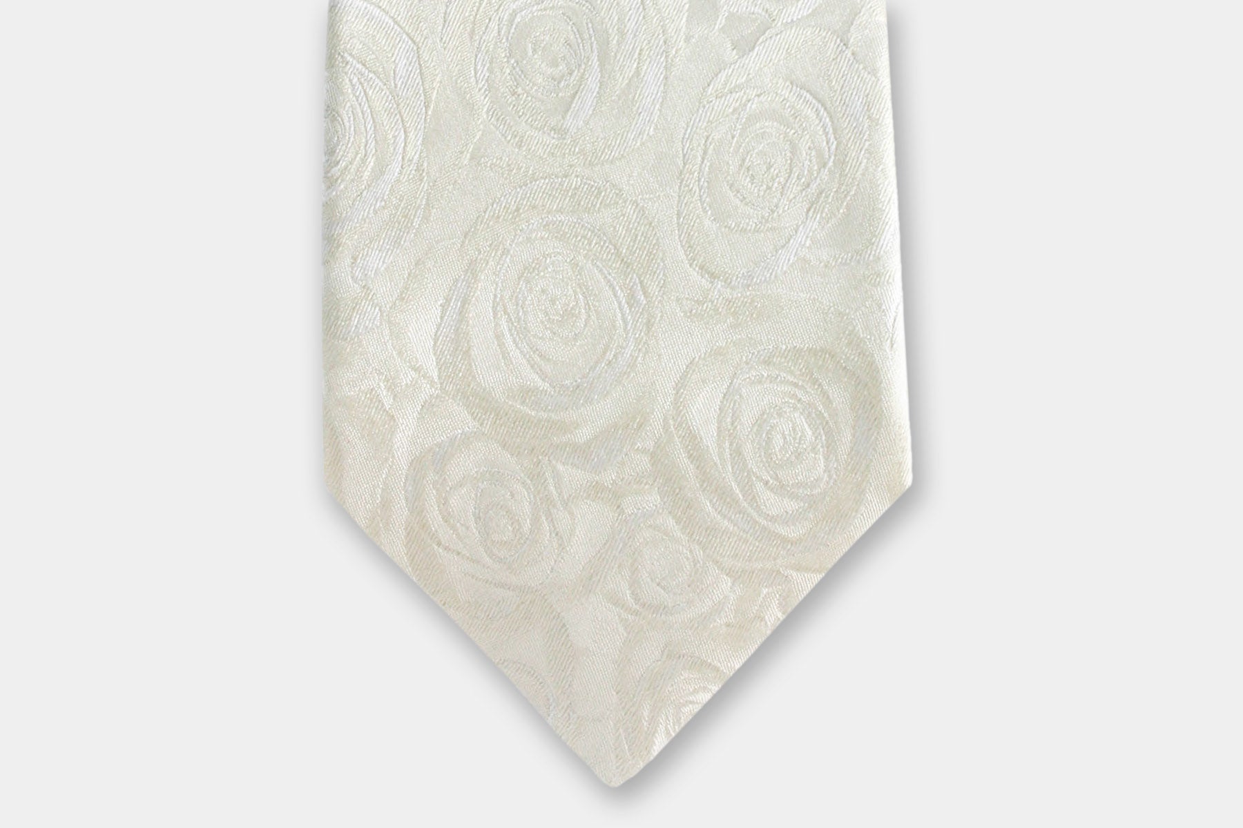 Close-up of a Robert Charles rose ivory silk tie highlighting fine Italian craftsmanship and perfectly suited for weddings.