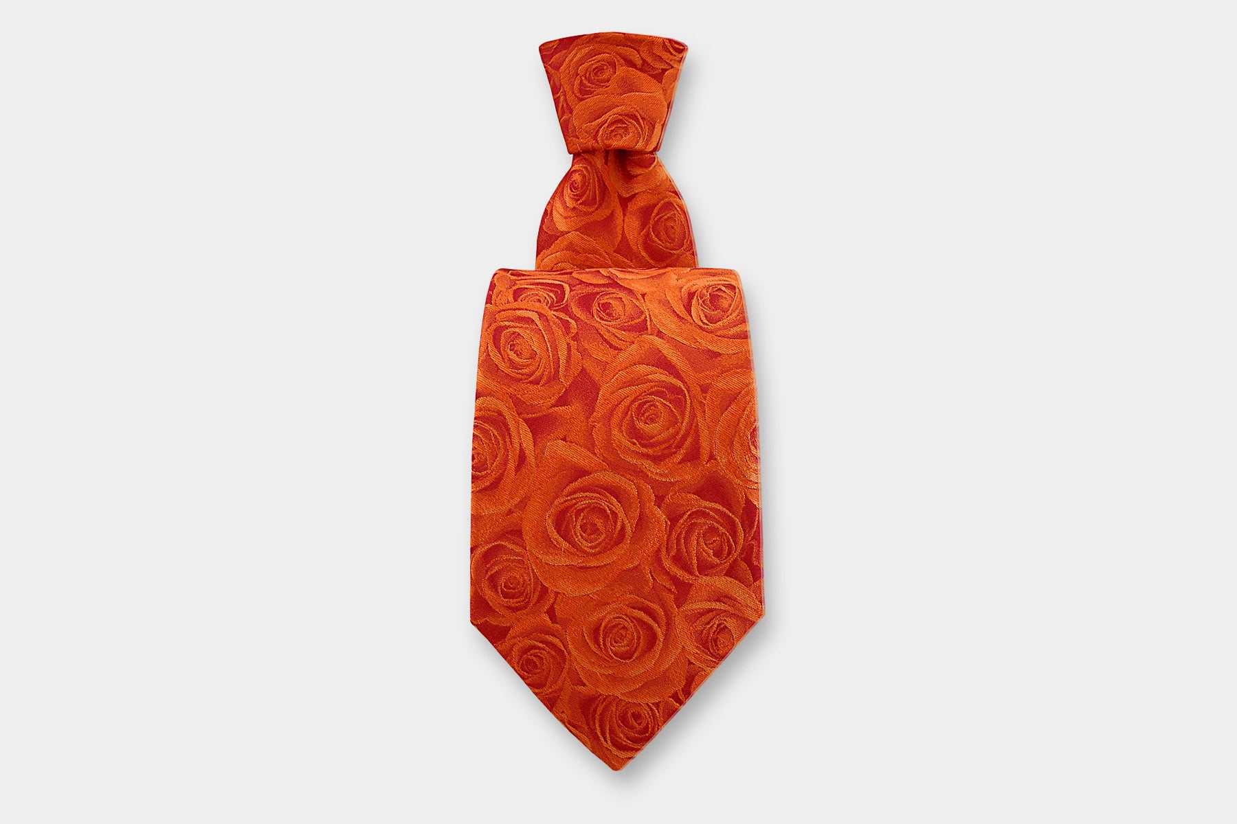 Robert Charles silk tie with a rose design in orange. Handmade in Italy, presented with a classic knot.