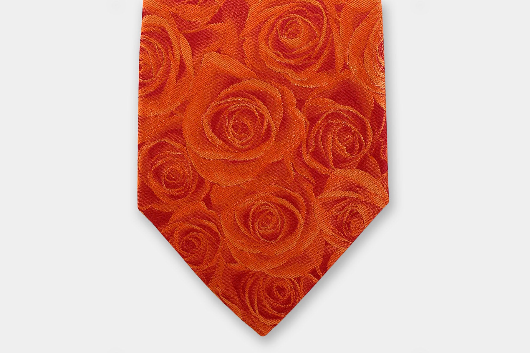 Close-up of a Robert Charles rose orange silk tie showcasing the fine Italian craftsmanship and intricate weave.