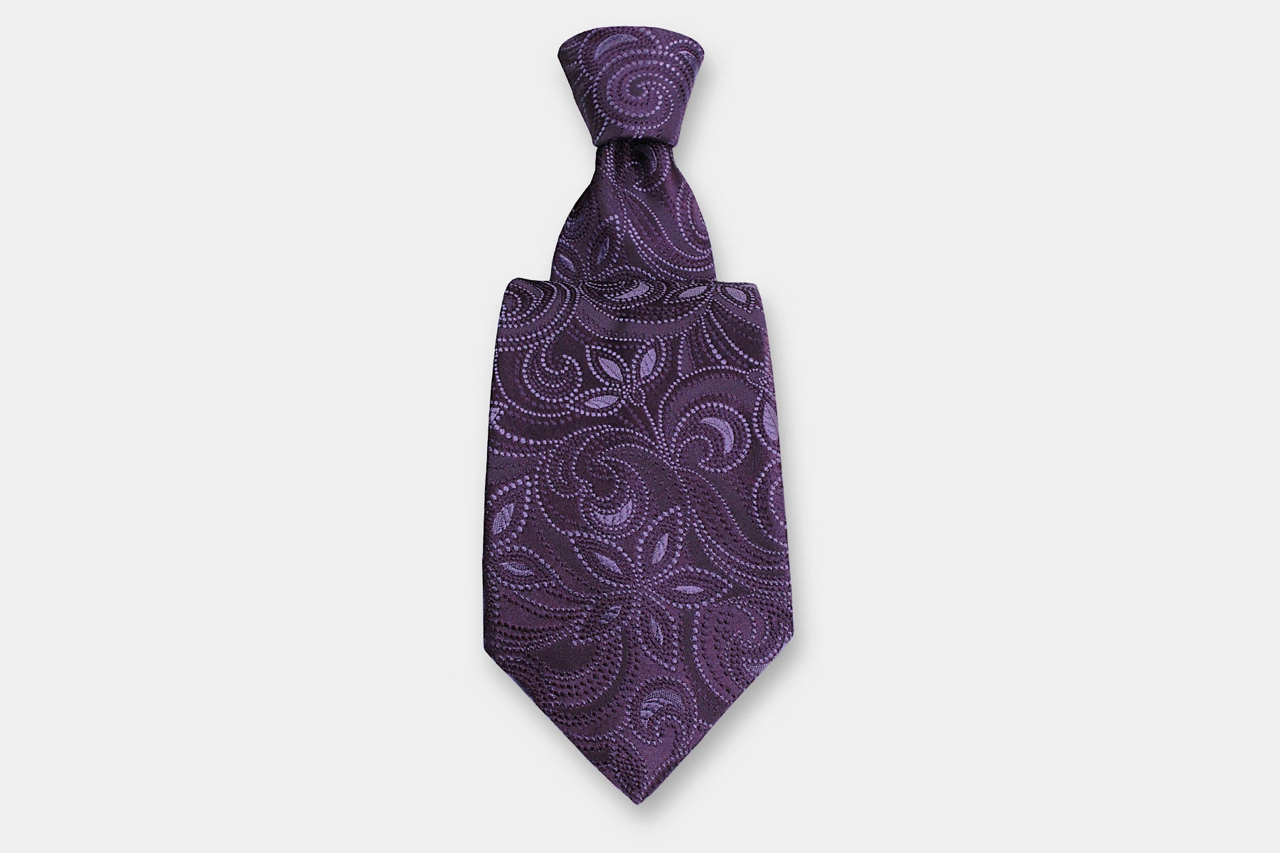 Robert Charles silk tie with a purple paisley design. Handmade in Italy, presented with a classic knot.